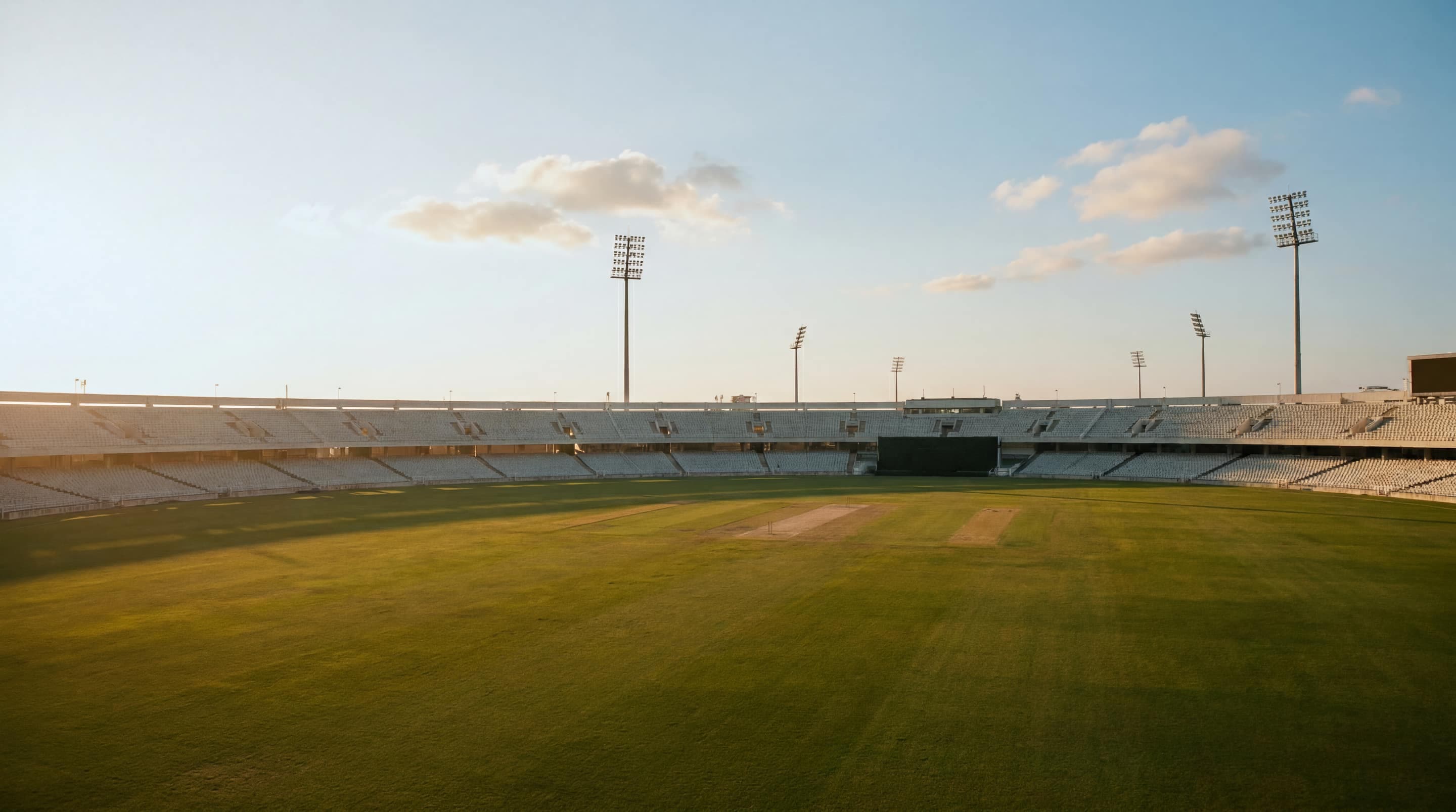 Empty cricket stadium in warm late-afternoon daylight